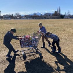Centennial kids push a cart loaded with food to the Food Bank on Kalum St.